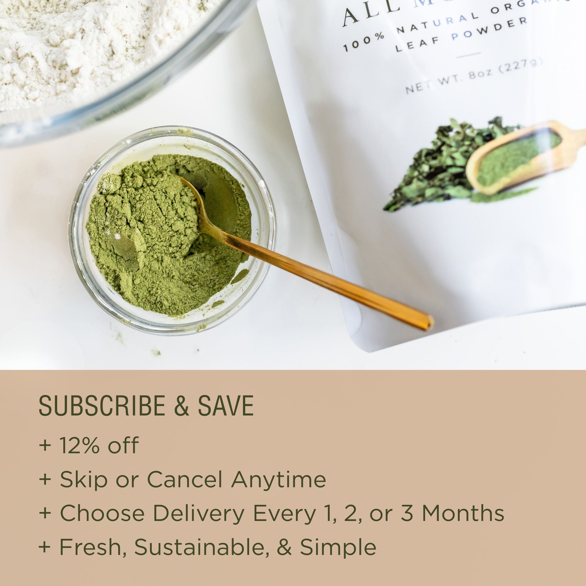 Jar of green powder with a spoon, next to a package of 8 oz moringa leaf powder, on a white surface.