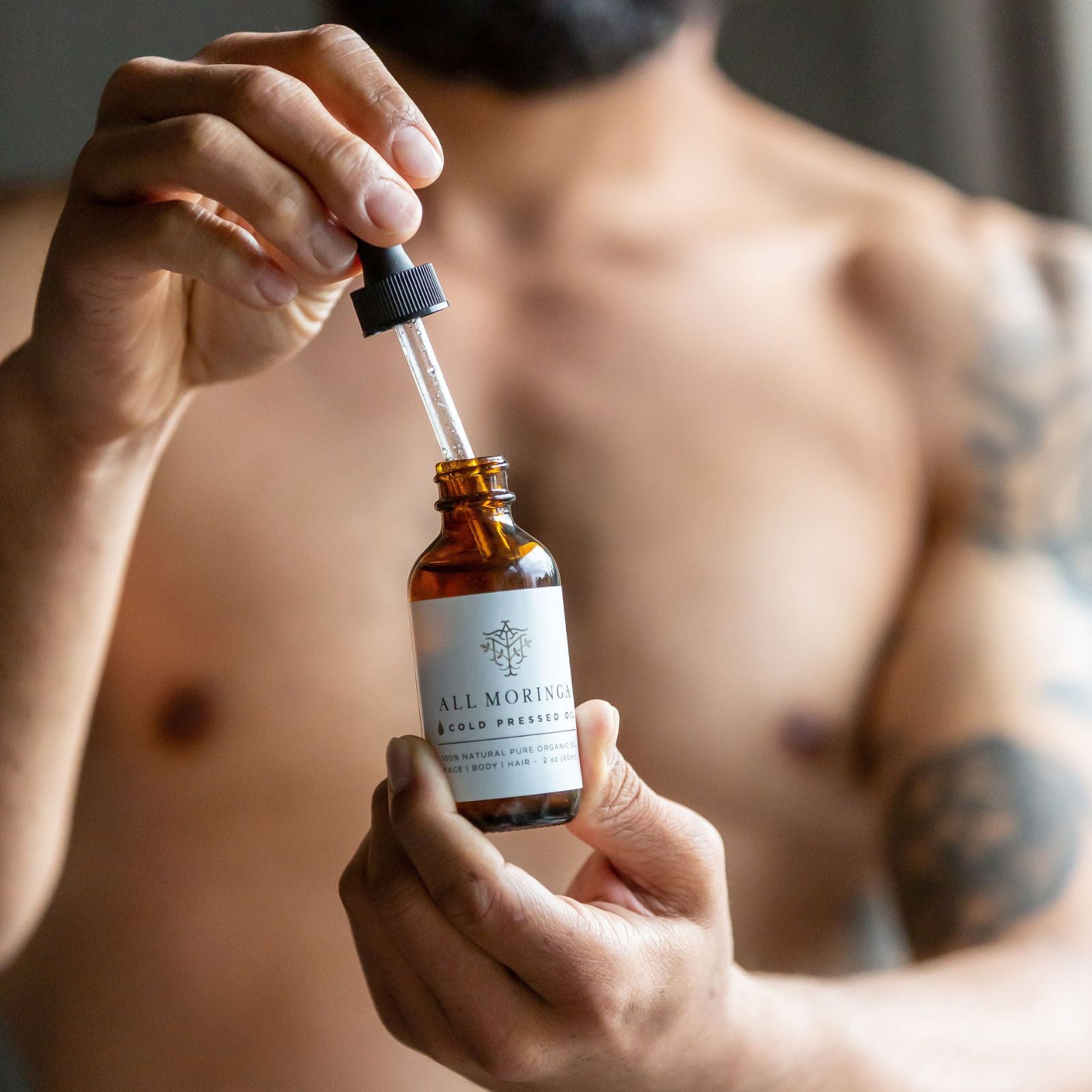 Dad using Moringa Seed Oil for skin, face, and beard care. Promoting natural skincare with Moringa Seed Oil, perfect for moisturizing skin and maintaining a healthy beard. Ideal Father's Day gift for natural and sustainable men's grooming.