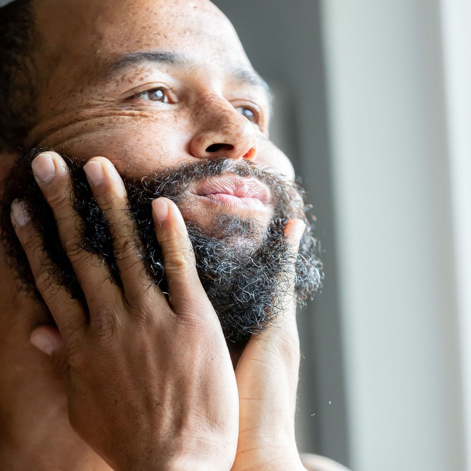 Dad using Moringa Seed Oil for skin, face, and beard care. Promoting natural skincare with Moringa Seed Oil, perfect for moisturizing skin and maintaining a healthy beard. Ideal Father's Day gift for natural and sustainable men's grooming.