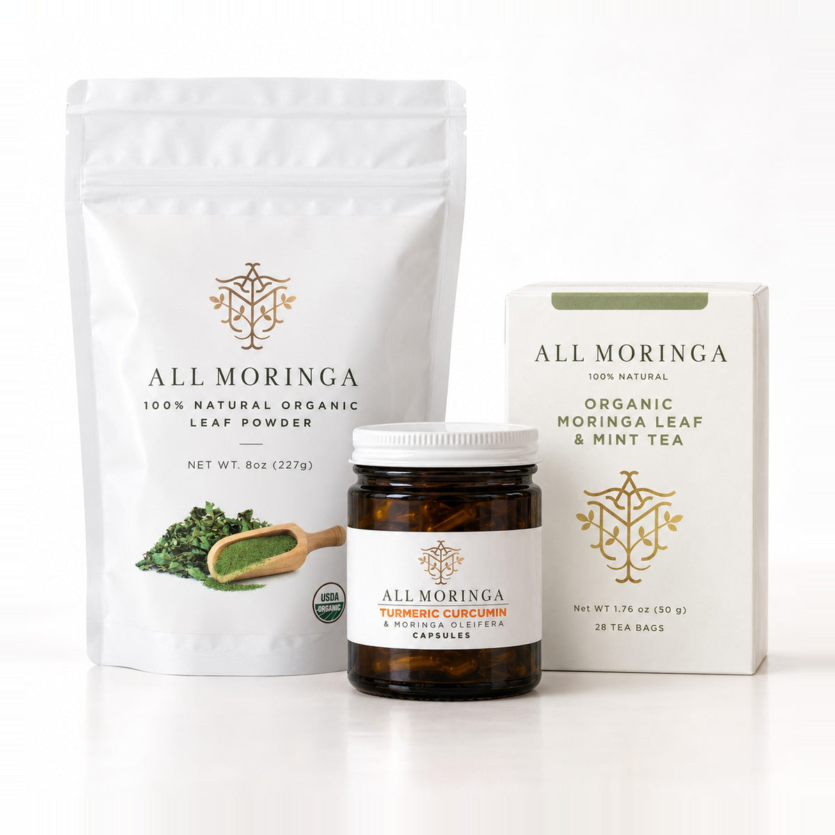 Essential Moringa & Turmeric Starter Kit: organic moringa leaf powder 8 oz pouch, turmeric curcumin and moringa capsules, and moringa mint & chamomile tea on white