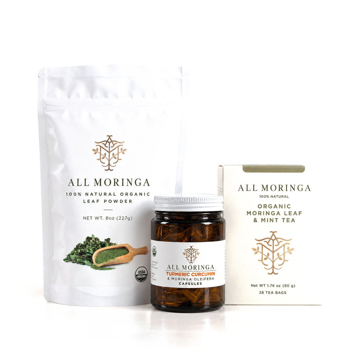 Essential Moringa & Turmeric Starter Kit: organic moringa leaf powder 8 oz pouch, turmeric curcumin and moringa capsules, and moringa mint & chamomile tea on white