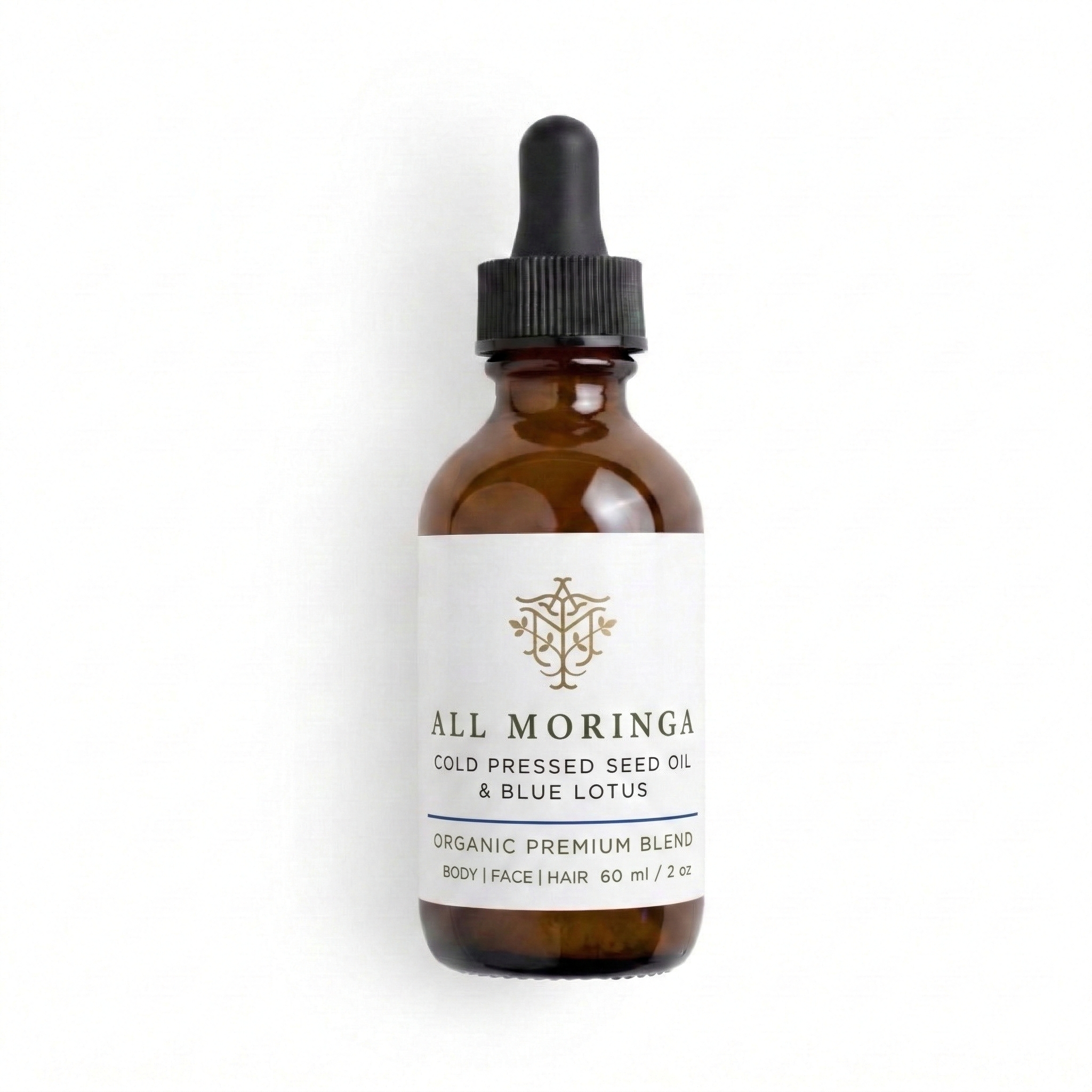 moringa oil and blue lotus in Brown glass bottle with dropper labeled All Moringa on a white background